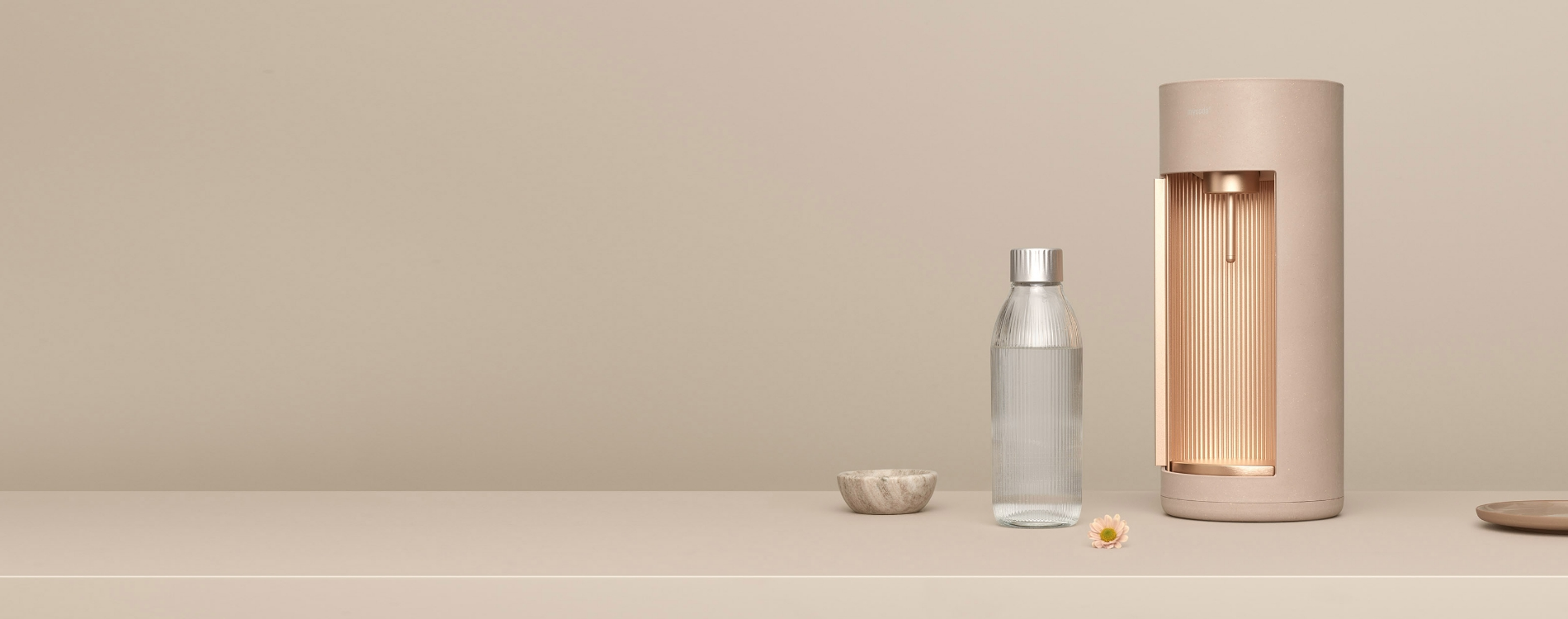 A Latte-coloured Glassy sparkling water maker and matching glass bottle