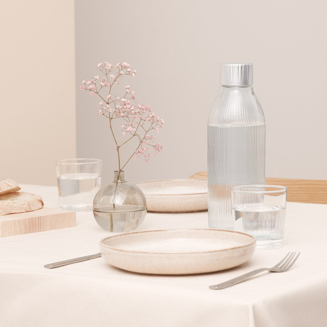 Mysoda glass bottle for sparkling water makers in an elegant table setting held in cream colours