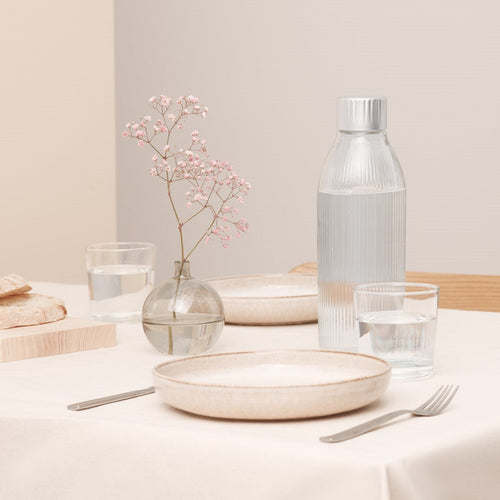 Mysoda glass bottle for sparkling water makers in an elegant table setting held in cream colours