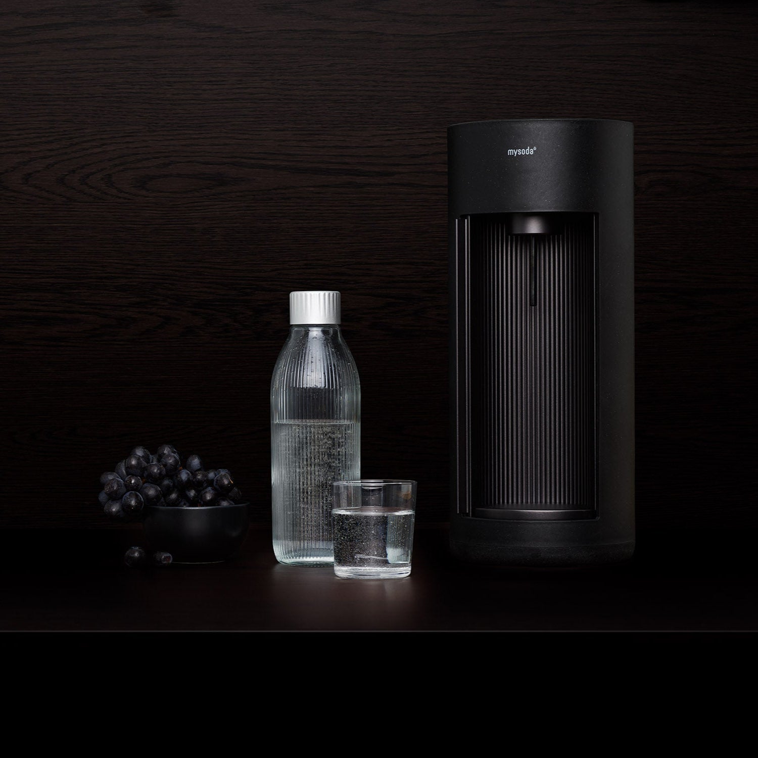 A black Glassy and elegant glass bottle in a black setting